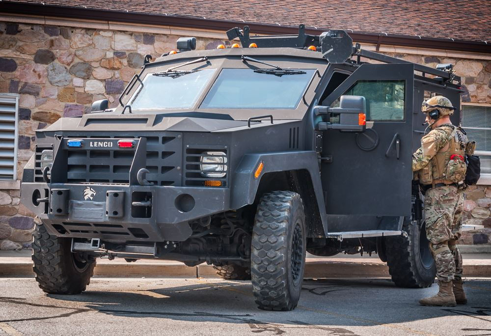 Kaysville SWAT Team member standing next to a SWAT vehicle.